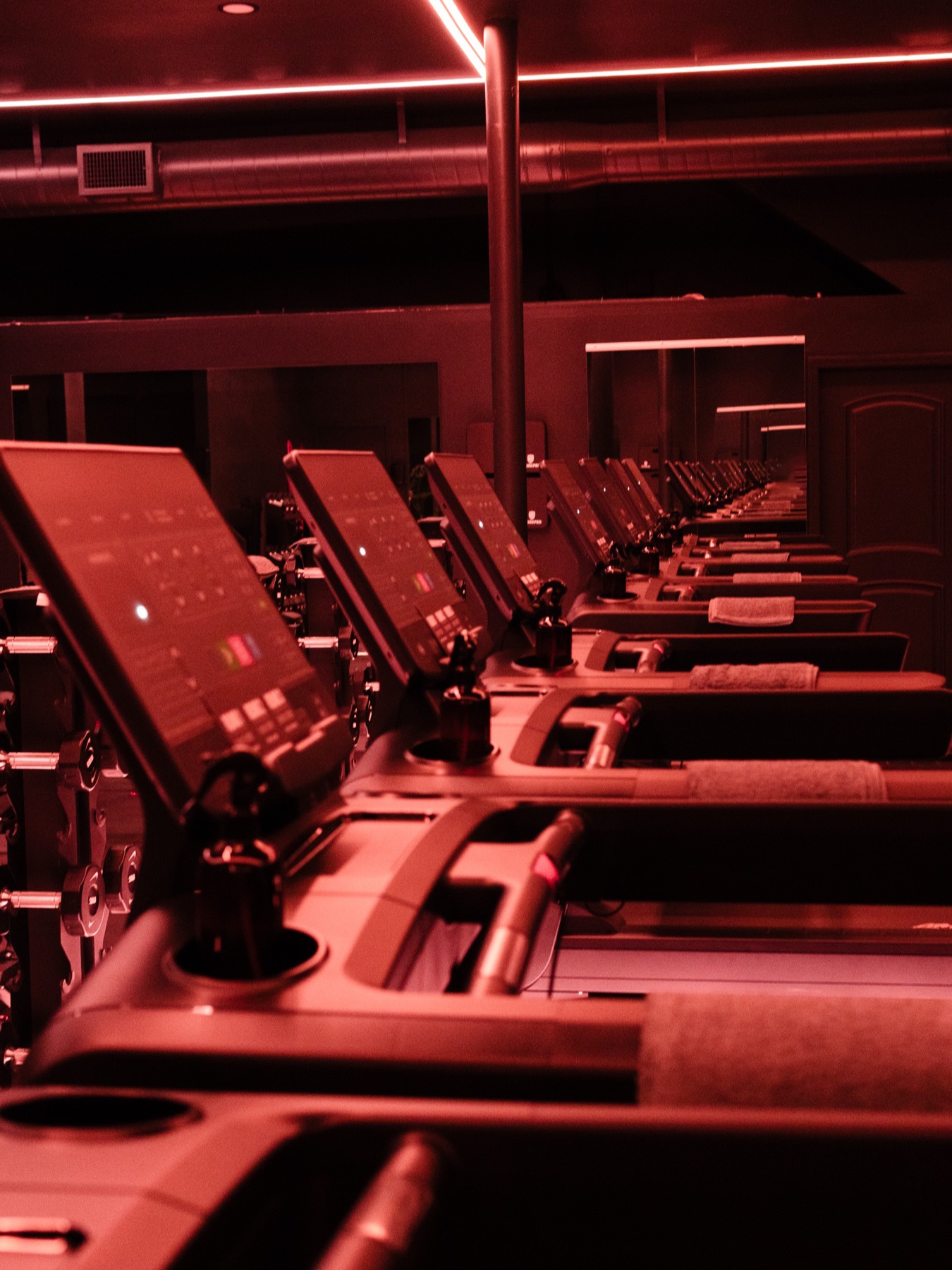 Treadmill row in the Society 3 cardio zone under red light